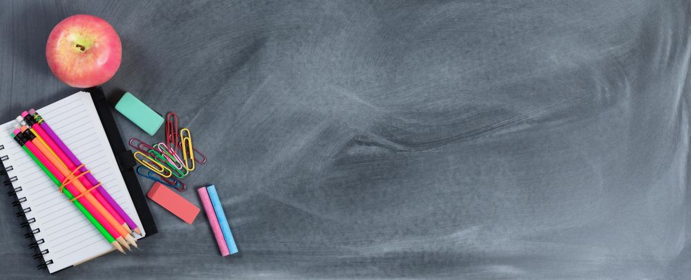 Back to school concept with erased chalkboard and student supplies