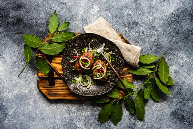 Top view of two abkhazura cutlets served on wooden board