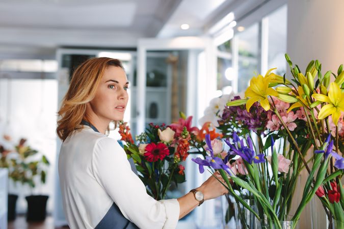 Young woman working in retail florist shop