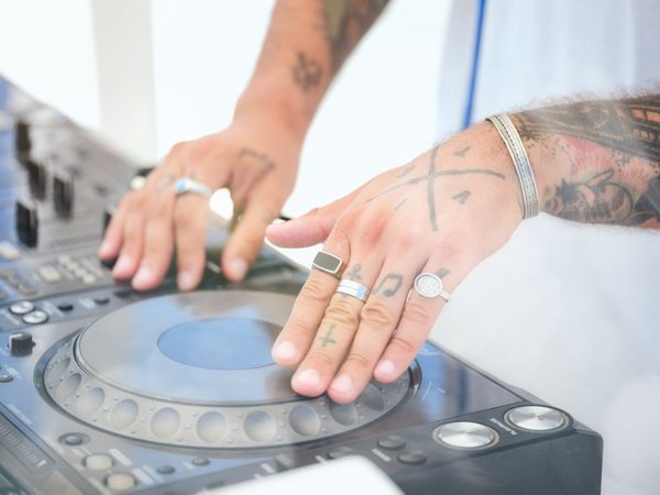 Crop DJ mixing music at disco party
