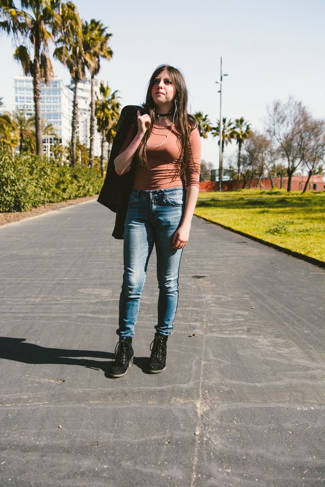 Teen girl walking happily through the streets of the city.