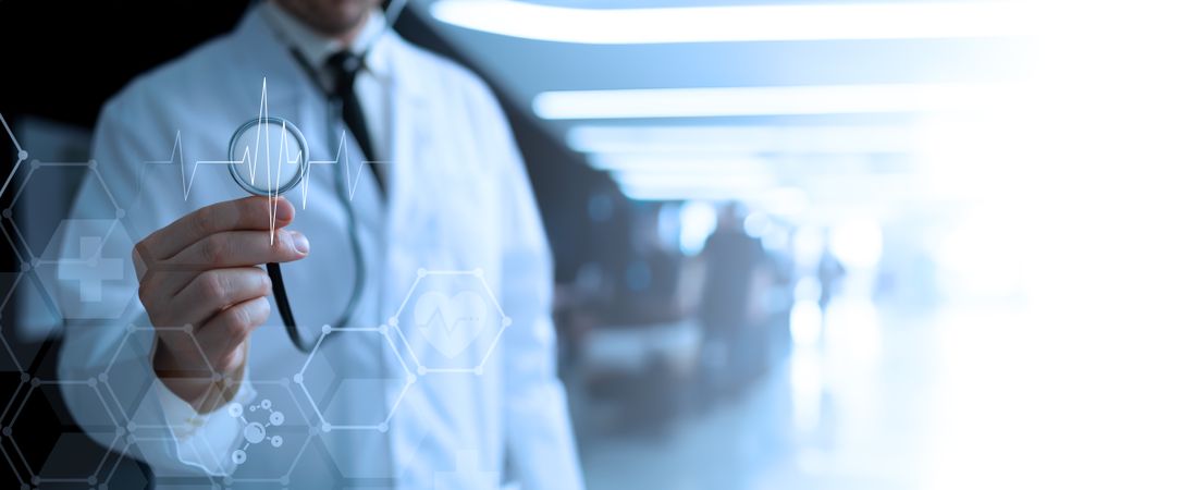Doctor holding stethoscope hospital background