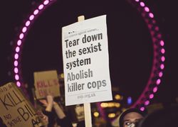 London, England, United Kingdom - March 16, 2021: Protest sign framed by London Eye