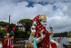 Red veiled Laksmi statue outside on cloudy day