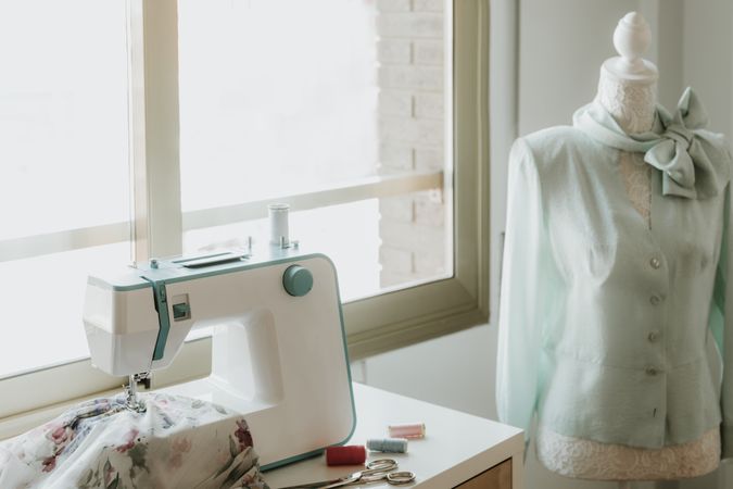Dummy with blouse near sewing machine