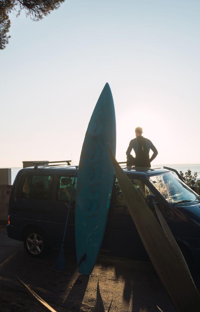Man enjoying the sunrise in his camped van