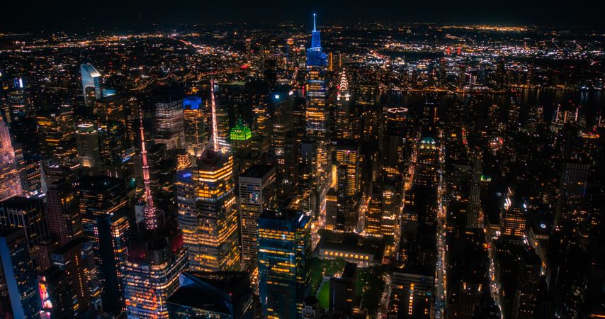 New York City Aerial Skyline with Historic and Modern Manhattan Skyscrapers and Residential Buildings at Night. Scenic Helicopter View of Popular Tourist and Business Attractions in the Dark
