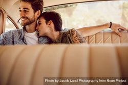 Couple snuggling in back seat of vintage car 4BOe3b