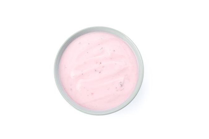 Bowl with fruit yogurt isolated on neutral background