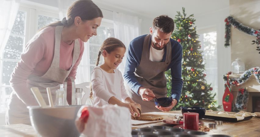 Family Celebrating the Holidays: Parents and Child Baking Together During Christmas.