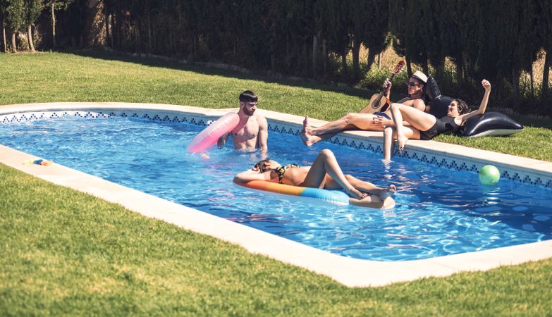 People relaxing in pool together