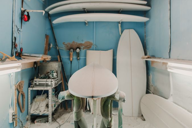 Workshop with surf boards near different tools