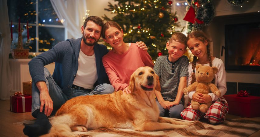Holiday Portrait of a Loving Family Posing for Camera, Smiling and Hugging Each Other.