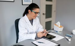 Female doctor using mobile while working
