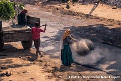Laborers building an asphalt road in a village in India 0yMej0
