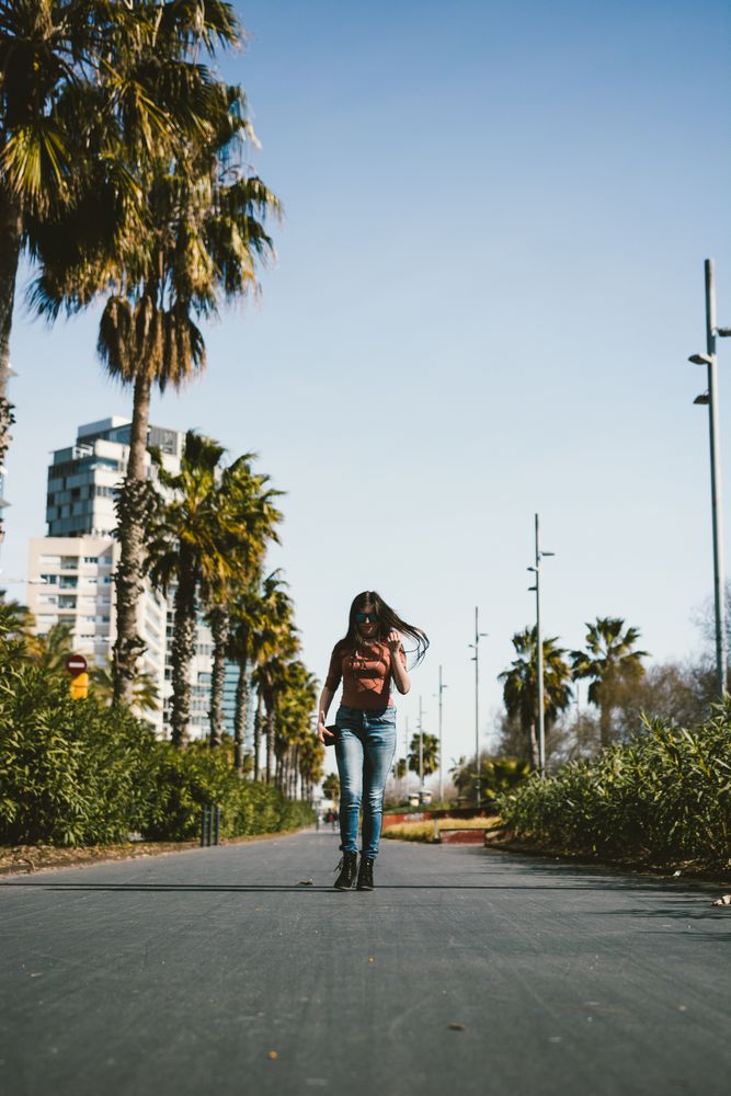 Teen girl walking happily through the streets.