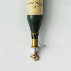 Collage made out of champagne bottle and paint tube