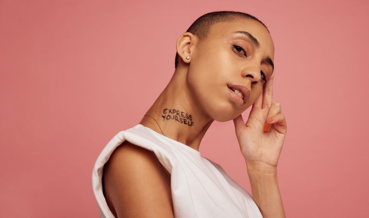 Portrait of a woman with express yourself written on her neck
