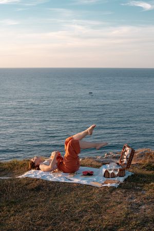 Woman resting in meadow on picnic