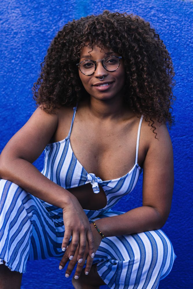Trendy female against bright wall