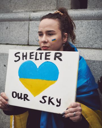 London, England, United Kingdom - March 5 2022: Woman with “Shelter Our Sky” sign