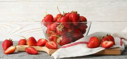Bowl with tasty strawberry on gray table. Summer berry