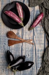 Ripe eggplants on shabby tabletop