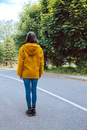 Anonymous woman walking along road