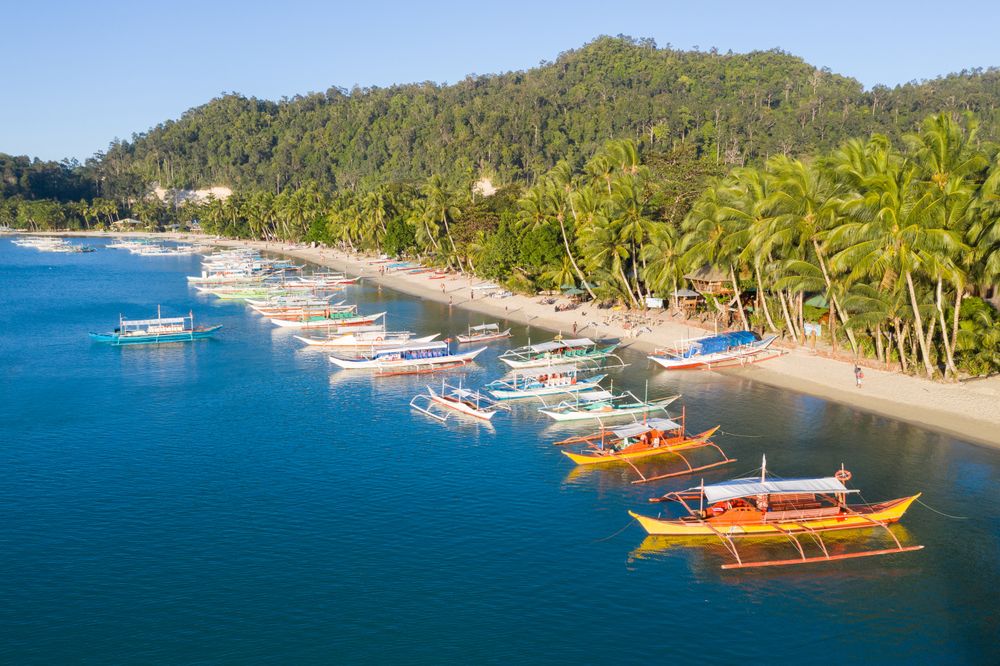Tropical seashore with colorful boats at rest
