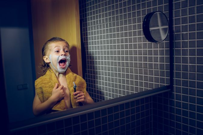 Excited boy with shaving razor