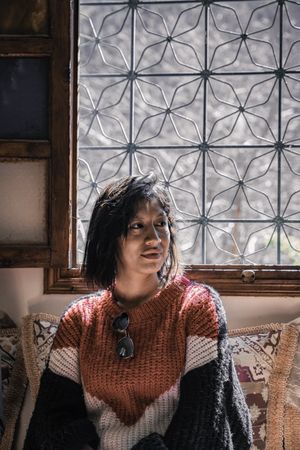 Peaceful woman resting by window