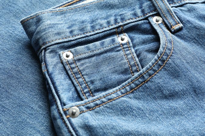 Closeup view of jeans pocket as background, space for text