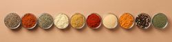 Banner of bowls of spices in row on beige table