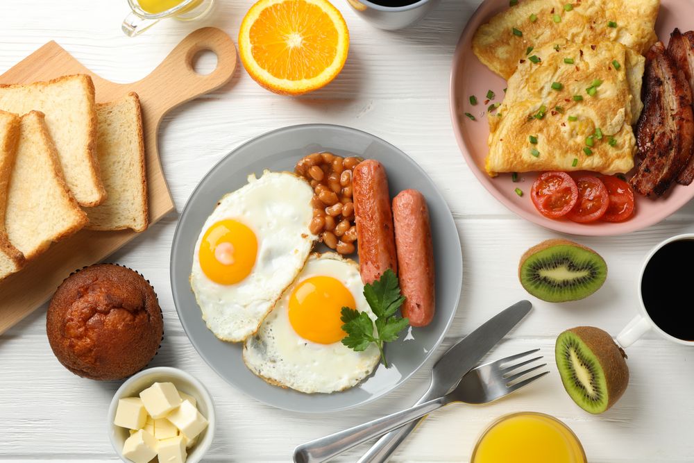 Full breakfast with eggs, beans, sausage, fruit and orange juice