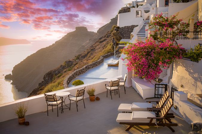 Patio with overhanging pink flowers at sunset in Greece