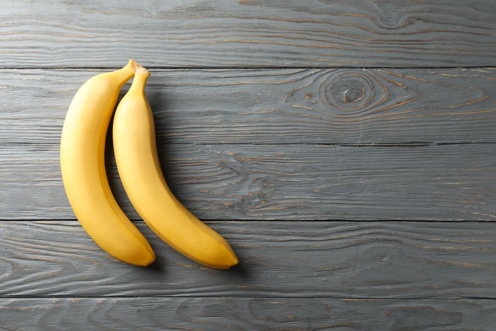 Bananas on gray wooden background. Fresh fruit