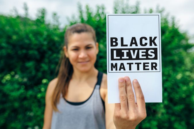 Woman showing symbol against racism