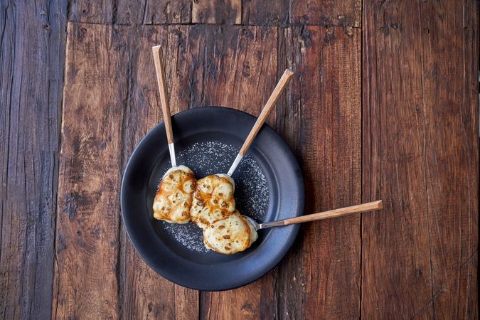 Delicious breakfast placed in plate on wooden table