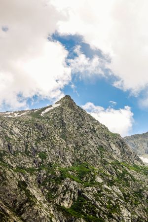 Peak of mountain with patches of grass