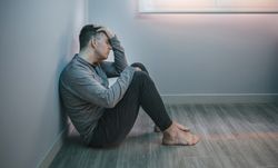 Man with problems resting sitting on the floor