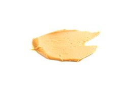 Creamy peanut butter isolated on bright background. A traditional product of American cuisine