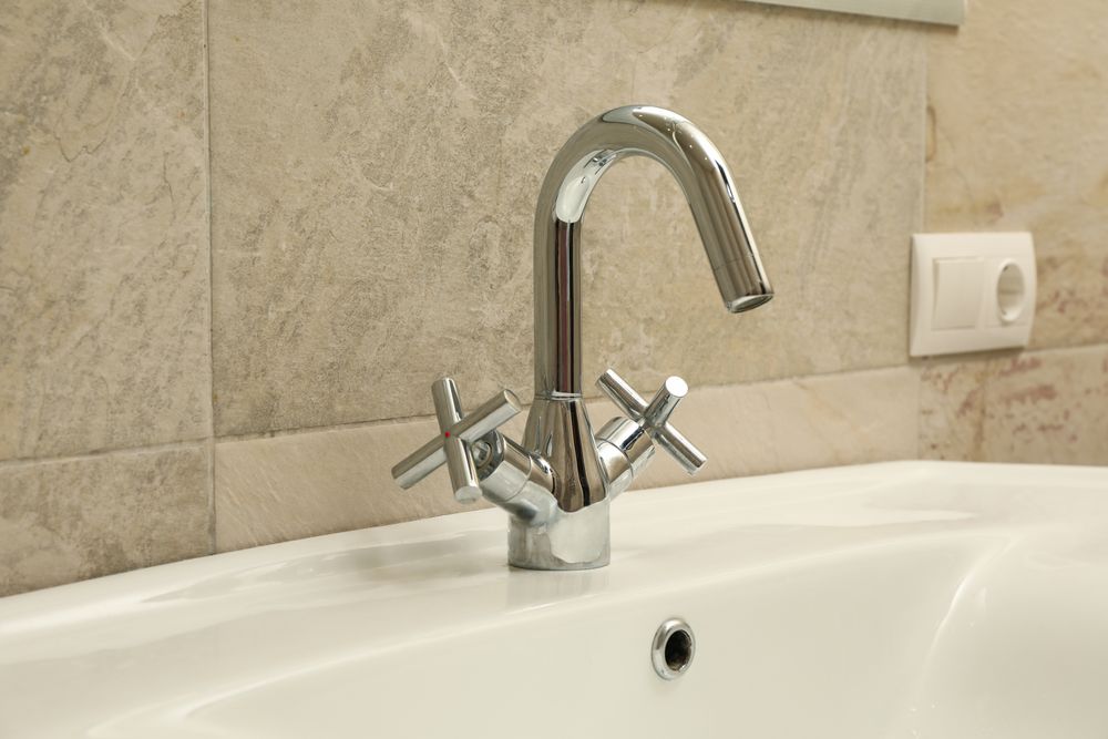 Sink and faucet in modern bathroom, close up