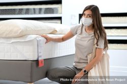 Woman in furniture store wearing surgical mask bDK2K4