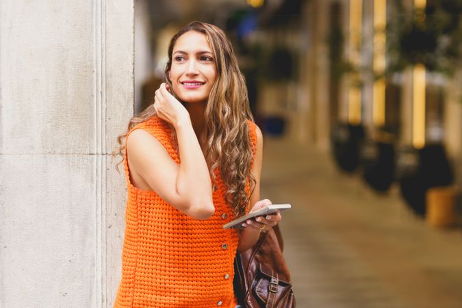 Woman waiting in the street using mobile