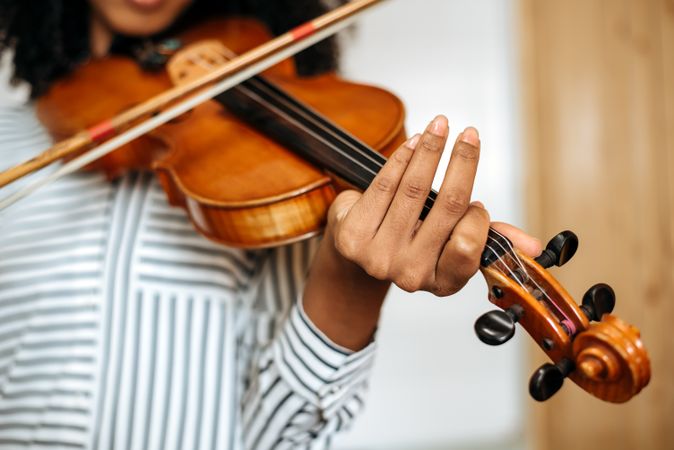 Woman playing violin in studio