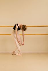 Ballet dancer leaning forward with arms hanging