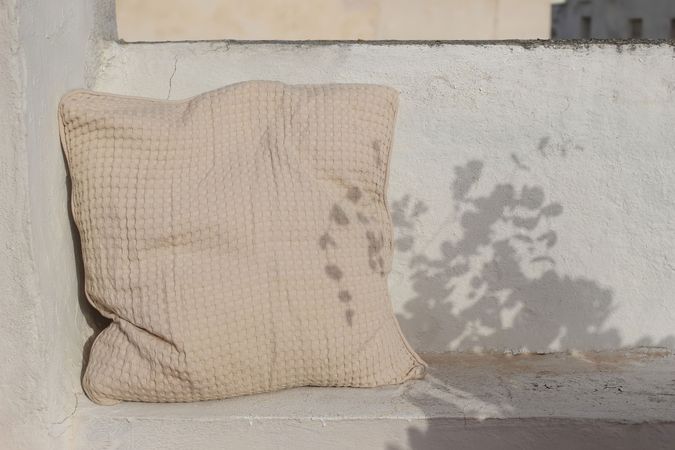 Cozy bench with beige cushion, pillow