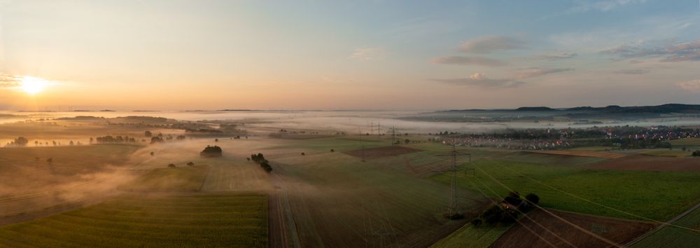 Golden hour drone photography of foggy agricultural landscapes in the morning
