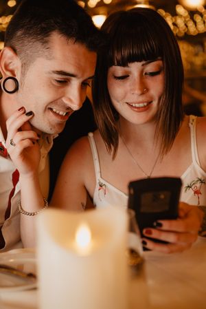 Couple using smartphone in luxury restaurant