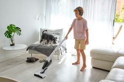 Boy cleaning light living room